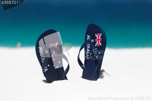 Image of Australia Flag thongs in the sand by the beach in summer