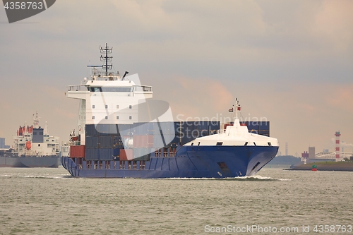 Image of Ship carrying containers through Rotterdam