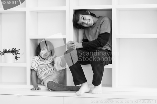 Image of young boys posing on a shelf