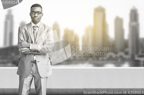 Image of Young black businessman in front of the big city