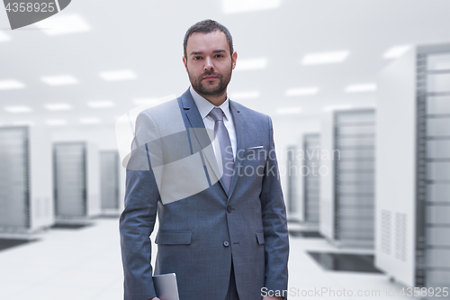 Image of Young businessman in server room