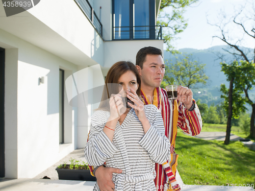 Image of Young beautiful couple in bathrobes