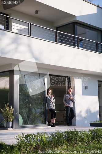 Image of couple enjoying on the door of their luxury home villa