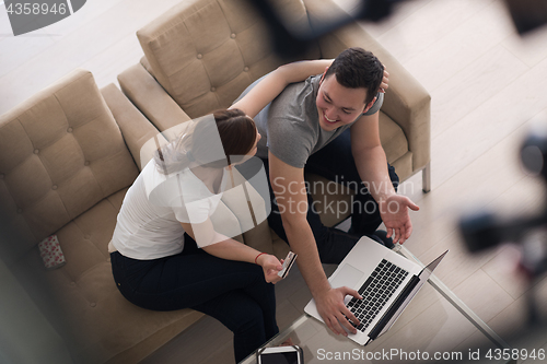 Image of happy young couple buying online