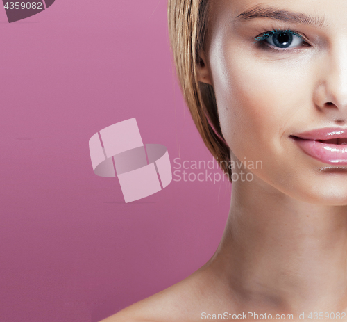 Image of young pretty blonde woman with hairstyle close up and makeup on pink 