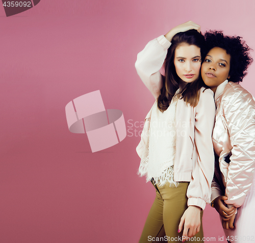 Image of different nation girls with diversuty in skin, hair. Asian, scandinavian, african american cheerful emotional posing on pink background, woman day celebration, lifestyle people concept