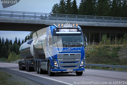 Image of Blue Volvo FH Milk Tanker and Highway Bridge