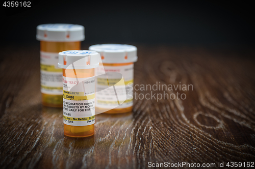 Image of Variety of Non-Proprietary Prescription Medicine Bottles on Refl