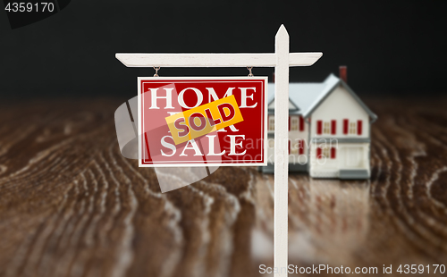 Image of Sold For Sale Real Estate Sign In Front of Model Home on Reflect
