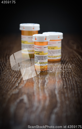 Image of Variety of Non-Proprietary Prescription Medicine Bottles on Refl