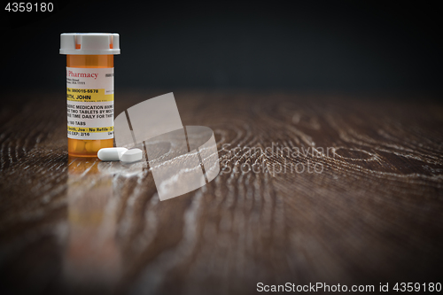 Image of Non-Proprietary Prescription Medicine Bottle and Pills on Reflec