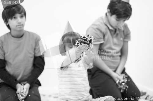 Image of kids  blowing confetti