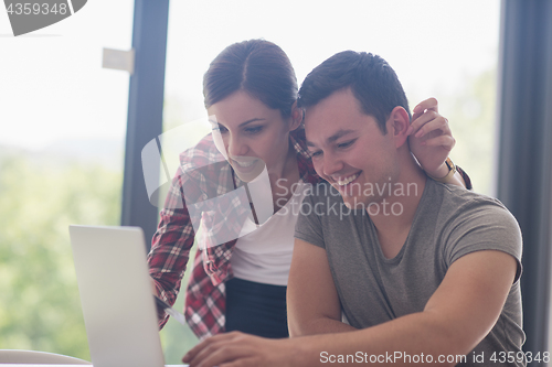 Image of happy young couple buying online