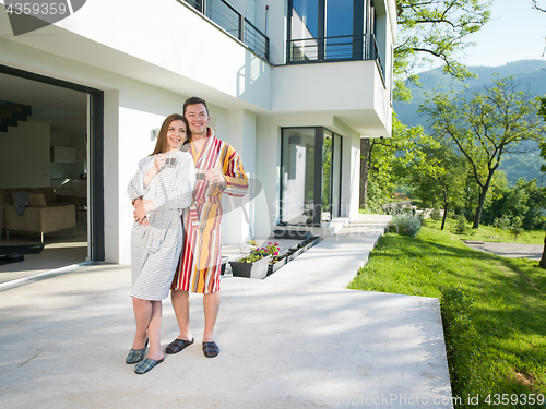 Image of Young beautiful couple in bathrobes