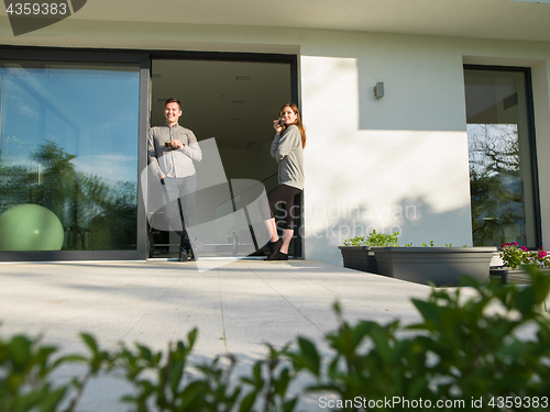 Image of couple enjoying on the door of their luxury home villa