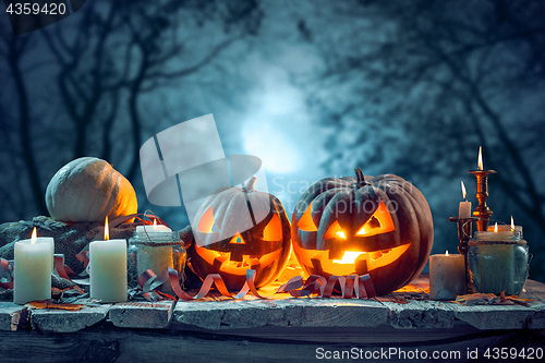 Image of Halloween pumpkins on blue background