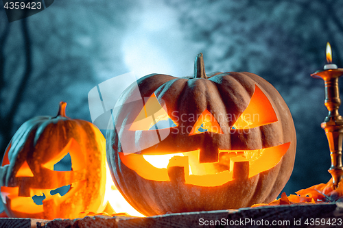 Image of Halloween pumpkins on blue background