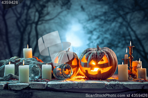 Image of Halloween pumpkins on blue background