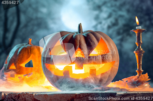 Image of Halloween pumpkins on blue background