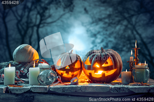 Image of Halloween pumpkins on blue background