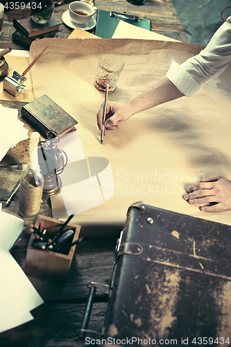 Image of Architect working on drawing table in office