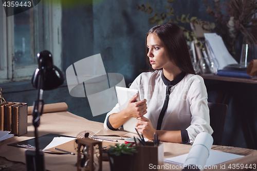 Image of Young beautiful woman working with laptop