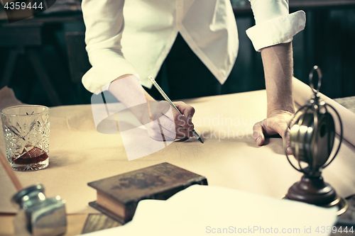 Image of Architect working on drawing table in office