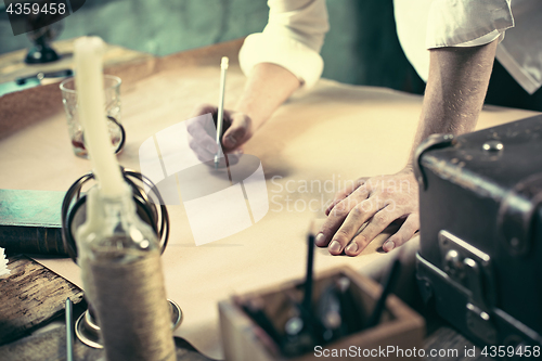 Image of Architect working on drawing table in office