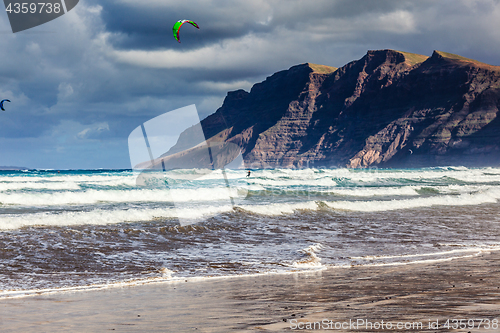 Image of Surfers and kiters in the water on Famara beach, Lanzarote