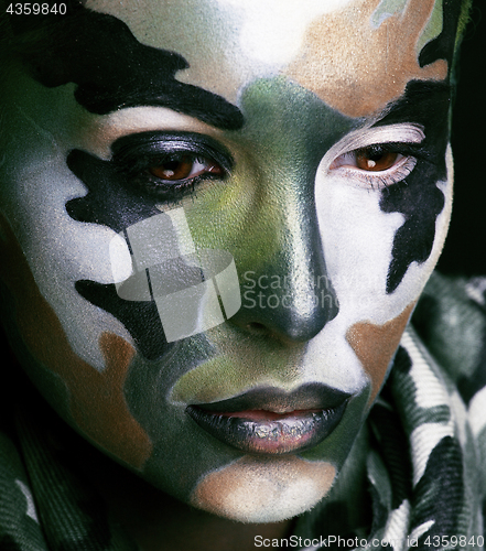 Image of Beautiful young fashion woman with military style clothing and face paint make-up, khaki colored