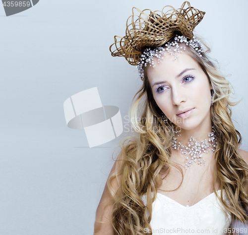 Image of beauty young snow queen with hair crown on her head, complicate 