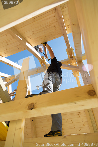 Image of Builders at work with wooden roof construction.