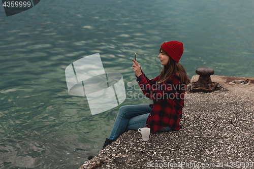 Image of Woman taking pictures with a cellphone