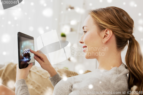 Image of smiling woman with signs of zodiac on tablet pc