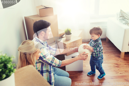 Image of happy family moving to new home and playing ball