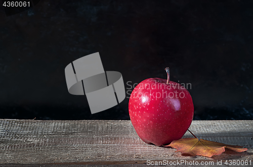 Image of Red ripe apple on a wooden table