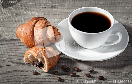 Image of Coffee and croissants on a wooden table