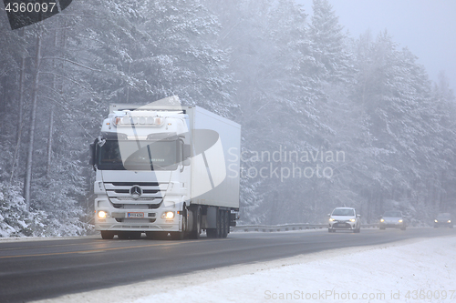 Image of White Cargo Truck in Winter Fog