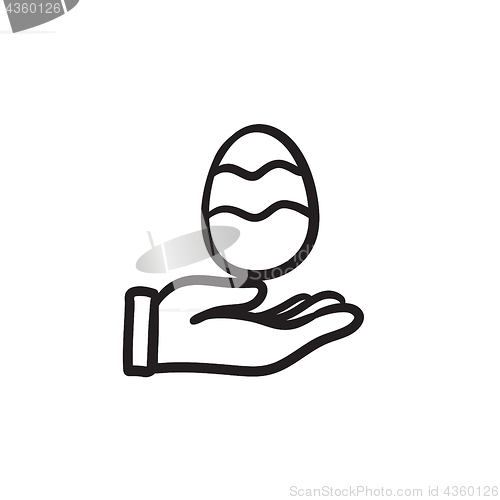 Image of Hand holding easter egg sketch icon.