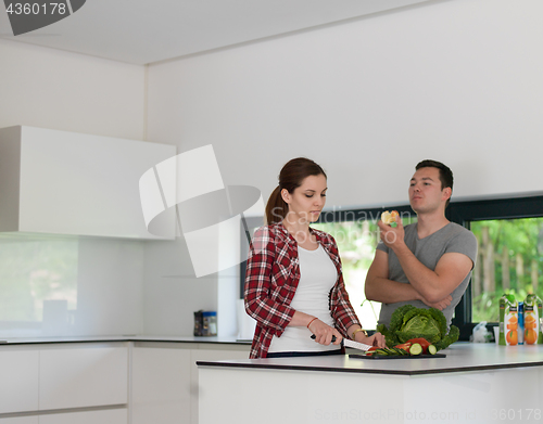 Image of Young handsome couple in the kitchen