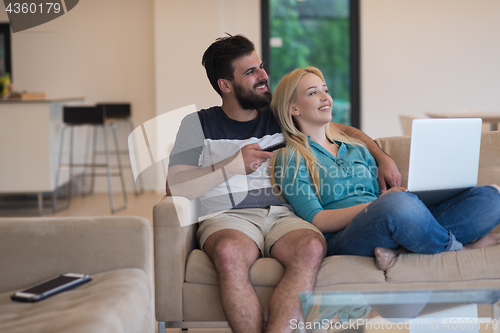 Image of young happy couple relaxes in the living room