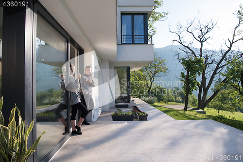 Image of couple enjoying on the door of their luxury home villa