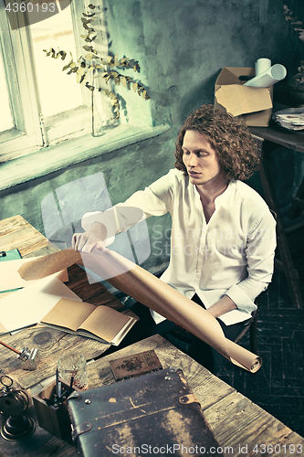 Image of Architect working on drawing table in office