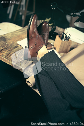 Image of Architect working on drawing table in office