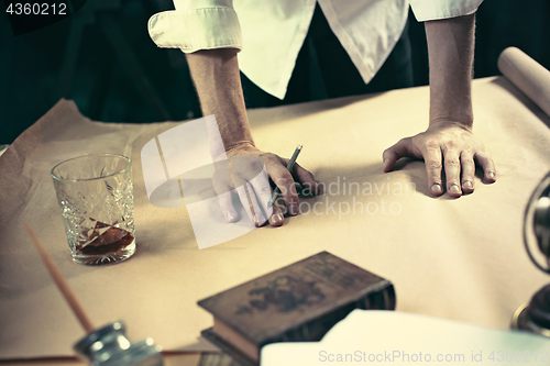 Image of Architect working on drawing table in office