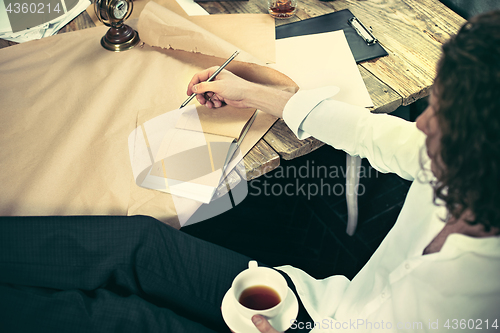 Image of Architect working on drawing table in office