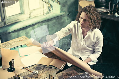 Image of Architect working on drawing table in office