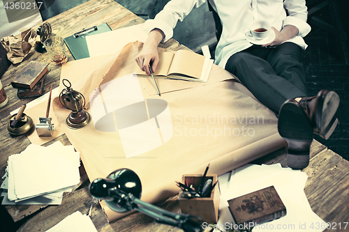 Image of Architect working on drawing table in office