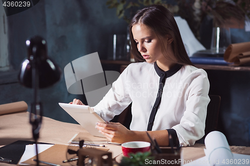 Image of Young beautiful woman working with laptop