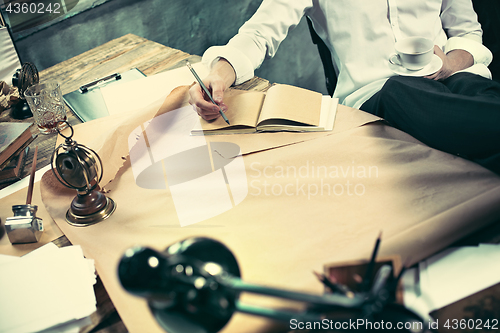 Image of Architect working on drawing table in office